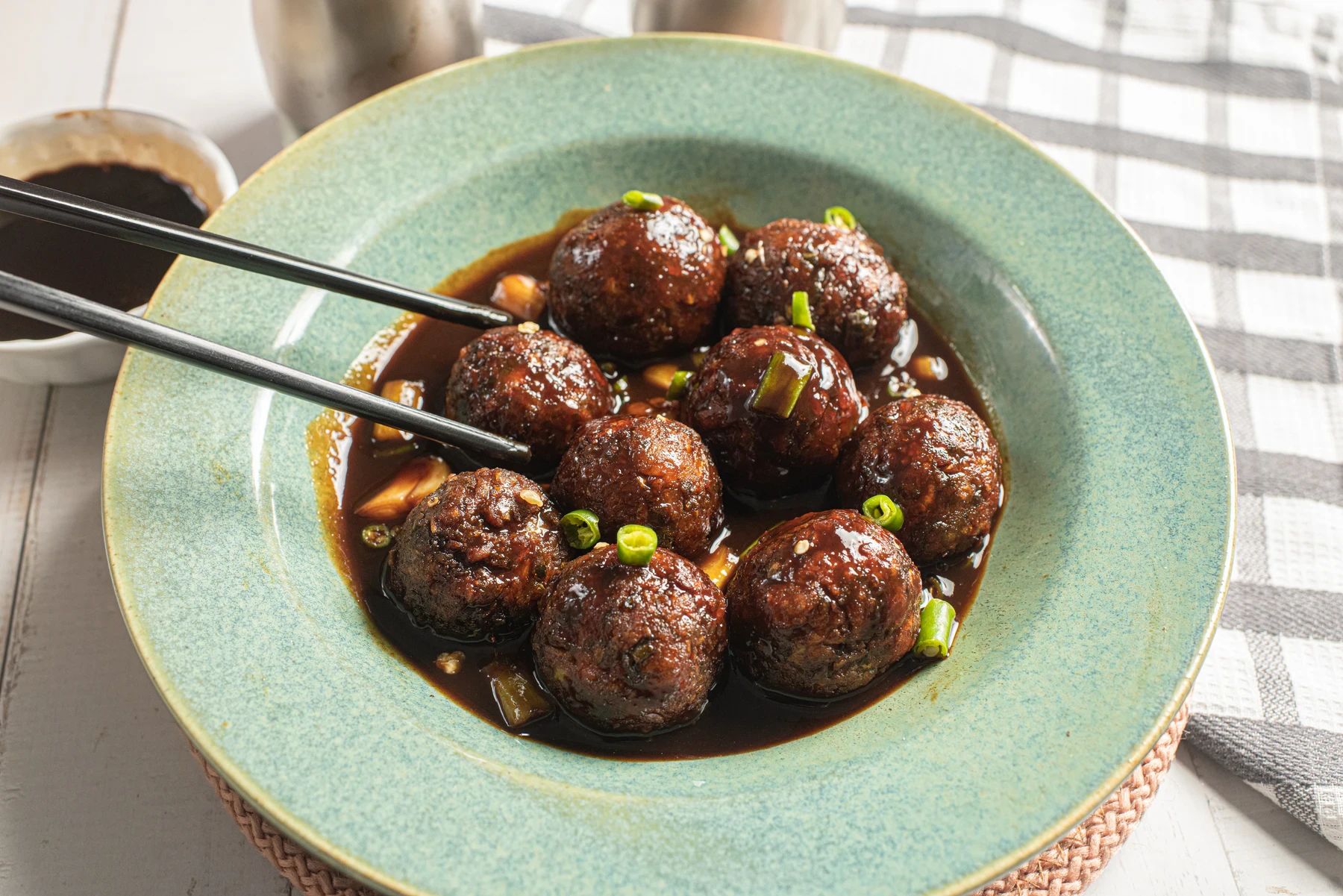 Vegetable Manchurian served in a rich sauce with spring onions
